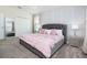 Charming bedroom featuring a tufted headboard, soft pink accents, and elegant decor at 8982 Cabot Cliffs Dr, Davenport, FL 33896