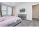Stylish bedroom with a plush bed, modern dresser, and a mounted television at 8982 Cabot Cliffs Dr, Davenport, FL 33896