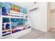 Charming bedroom featuring a playful Toy Story themed bunk bed and closet at 8982 Cabot Cliffs Dr, Davenport, FL 33896