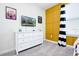 Bright bedroom with a white dresser, mounted TV, and colorful decor at 8982 Cabot Cliffs Dr, Davenport, FL 33896