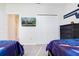 Themed bedroom with a mounted television and modern furnishings at 8982 Cabot Cliffs Dr, Davenport, FL 33896