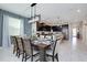 Open-concept dining area featuring a modern light fixture and stylish decor at 8982 Cabot Cliffs Dr, Davenport, FL 33896