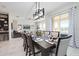 Open-concept dining area featuring a modern light fixture and stylish decor at 8982 Cabot Cliffs Dr, Davenport, FL 33896