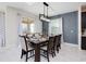 Open-concept dining area featuring a modern light fixture and stylish decor at 8982 Cabot Cliffs Dr, Davenport, FL 33896