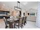 Open-concept dining area featuring a modern light fixture and stylish decor at 8982 Cabot Cliffs Dr, Davenport, FL 33896
