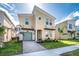 Modern two-story home with stylish facade, beautiful landscaping, and a two-car garage at 8982 Cabot Cliffs Dr, Davenport, FL 33896