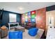 Inviting game room with a plush sofa, foosball table, and whimsical social media wall art at 8982 Cabot Cliffs Dr, Davenport, FL 33896