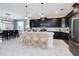 Open kitchen with an island, chairs, stainless steel appliances, and an adjacent dining area at 8982 Cabot Cliffs Dr, Davenport, FL 33896