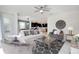 Spacious living room featuring stylish furniture, ceiling fan, and lots of natural light at 8982 Cabot Cliffs Dr, Davenport, FL 33896