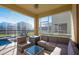 Comfortable screened-in patio area with stylish outdoor seating and a view of the pool at 8982 Cabot Cliffs Dr, Davenport, FL 33896