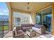 Comfortable screened-in patio area with stylish outdoor seating and a view of the backyard at 8982 Cabot Cliffs Dr, Davenport, FL 33896