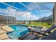 Inviting screened-in pool and spa area with comfortable lounge chairs and beautiful backyard views at 8982 Cabot Cliffs Dr, Davenport, FL 33896