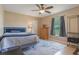 Well-lit bedroom featuring a ceiling fan, window, and neutral wall paint color at 929 Louvre Ct, Kissimmee, FL 34759