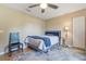 Cozy bedroom featuring a ceiling fan, hardwood floors, and a neutral wall paint color at 929 Louvre Ct, Kissimmee, FL 34759