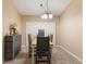 Traditional dining room with a wood table, four chairs, and neutral carpet at 929 Louvre Ct, Kissimmee, FL 34759