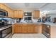 Bright kitchen featuring wooden cabinets, white tile floors and countertops, and stainless steel appliances at 929 Louvre Ct, Kissimmee, FL 34759