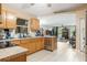 Modern kitchen with a view into the living room, stainless steel appliances, and tile flooring at 929 Louvre Ct, Kissimmee, FL 34759