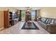 Cozy living room featuring tile floors, a ceiling fan, and bright windows at 929 Louvre Ct, Kissimmee, FL 34759