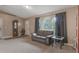 Comfortable living room with neutral carpet, large window, and relaxed seating at 929 Louvre Ct, Kissimmee, FL 34759