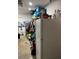 Basement storage featuring shelving, a refrigerator, and various household items at 976 Alicante Ave, Orlando, FL 32807
