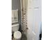 Bathroom features a toilet, patterned curtain, and a towel rack on painted walls at 976 Alicante Ave, Orlando, FL 32807