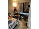 Messy bedroom featuring tile flooring, curtains, and various personal items at 976 Alicante Ave, Orlando, FL 32807