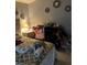 Bedroom showcasing bed, neutral walls, dark wooden nightstand, and tile flooring at 976 Alicante Ave, Orlando, FL 32807