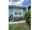 Landscaping detail with decorative bunnies and bright yellow flowering bush at 976 Alicante Ave, Orlando, FL 32807