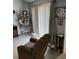 Living room area with comfortable recliner and decorative photo display at 976 Alicante Ave, Orlando, FL 32807