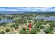 Picturesque aerial shot of the property nestled among lush trees, near a lake, showcasing its serene location at 10697 Lake Hill Dr, Clermont, FL 34711