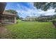 Expansive backyard with a screened-in porch and views of the surrounding greenery at 10697 Lake Hill Dr, Clermont, FL 34711