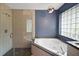 Modern bathroom featuring a glass-enclosed shower and a luxurious soaking tub at 10697 Lake Hill Dr, Clermont, FL 34711