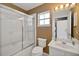 Bathroom featuring a glass-enclosed shower, vanity, and ample lighting at 10697 Lake Hill Dr, Clermont, FL 34711
