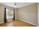Well-lit bedroom features a window with backyard views and laminate flooring at 10697 Lake Hill Dr, Clermont, FL 34711