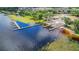 Aerial view of a community boat ramp and dock on a beautiful lake surrounded by lush green trees and landscaping at 10697 Lake Hill Dr, Clermont, FL 34711