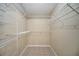 Well-organized walk-in closet with ample shelving and tiled flooring at 10697 Lake Hill Dr, Clermont, FL 34711