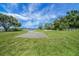 Lawn area with mature trees and water views at 10697 Lake Hill Dr, Clermont, FL 34711