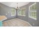 Bright dining area features tile floors, natural light, and chandelier lighting fixture at 10697 Lake Hill Dr, Clermont, FL 34711