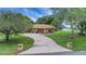 Wide driveway leading to the two-car garage, complemented by well-maintained landscaping and mature shade trees at 10697 Lake Hill Dr, Clermont, FL 34711