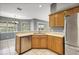 Functional kitchen with wood cabinetry, stainless steel appliances, and a breakfast nook at 10697 Lake Hill Dr, Clermont, FL 34711