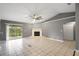 Large living room with fireplace and sliding door at 10697 Lake Hill Dr, Clermont, FL 34711