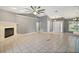 Open living room with tile flooring, fireplace, and bright entryway at 10697 Lake Hill Dr, Clermont, FL 34711
