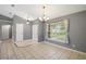 Open-concept living area with tile flooring and abundant natural light at 10697 Lake Hill Dr, Clermont, FL 34711