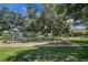 Community playground with swings and mature trees at 10697 Lake Hill Dr, Clermont, FL 34711