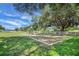 Community playground with swings and mature trees at 10697 Lake Hill Dr, Clermont, FL 34711