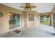 Relaxing enclosed porch featuring a ceiling fan and views of the lush backyard and sparkling pool at 10697 Lake Hill Dr, Clermont, FL 34711