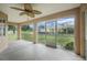 Enclosed porch with a ceiling fan, offering a relaxing outdoor space at 10697 Lake Hill Dr, Clermont, FL 34711
