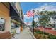 Charming street view with American flags, quaint storefronts, and tree-lined sidewalks at 10697 Lake Hill Dr, Clermont, FL 34711
