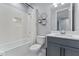 Cozy bathroom featuring a tub and shower combination, gray vanity with a quartz countertop, and modern geometric decor at 1224 Hillcrest View Loop, Apopka, FL 32703