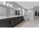 Bright bathroom featuring a double vanity, soaking tub, and walk-in shower with modern fixtures at 1224 Hillcrest View Loop, Apopka, FL 32703